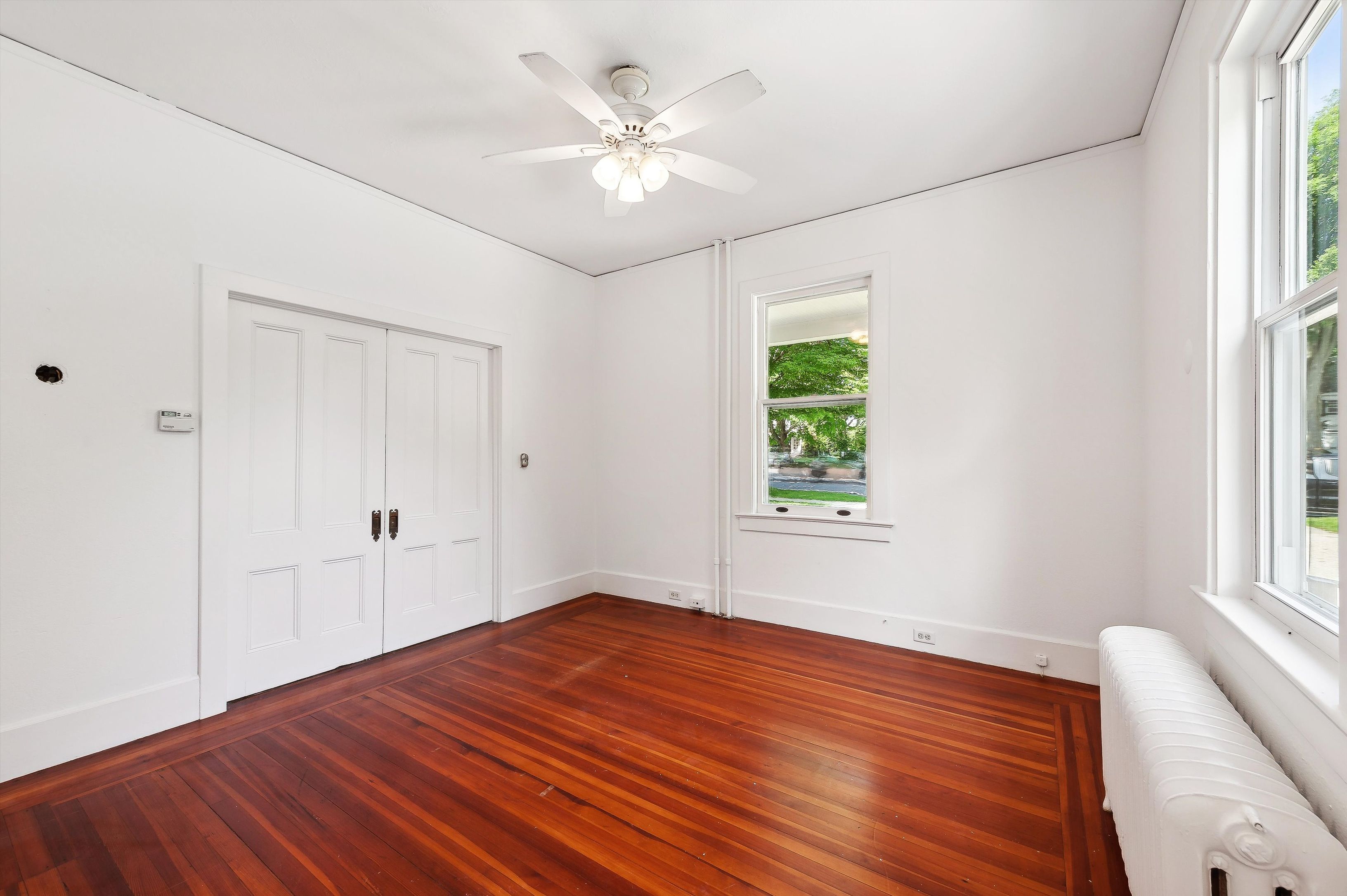 10 Pantigo Road East Hampton, NY 11937 - Photo 15 of 28 wooden floor in an empty room with a window