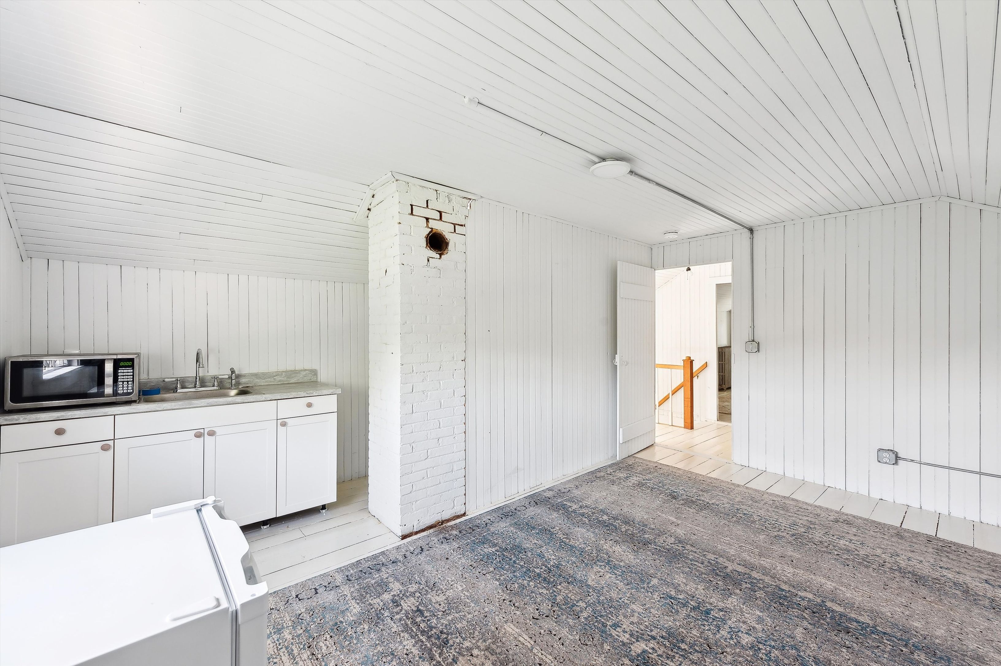 10 Pantigo Road East Hampton, NY 11937 - Photo 25 of 28 a large white kitchen with a sink and cabinets