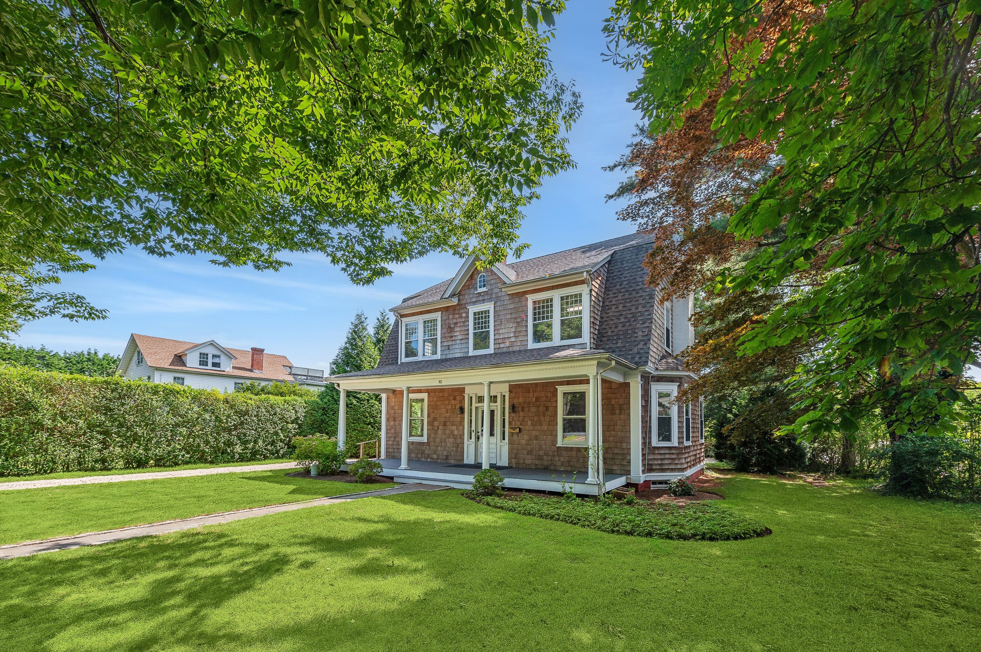 10 Pantigo Road East Hampton, NY 11937 - Photo 3 of 28 a front view of a house with a garden