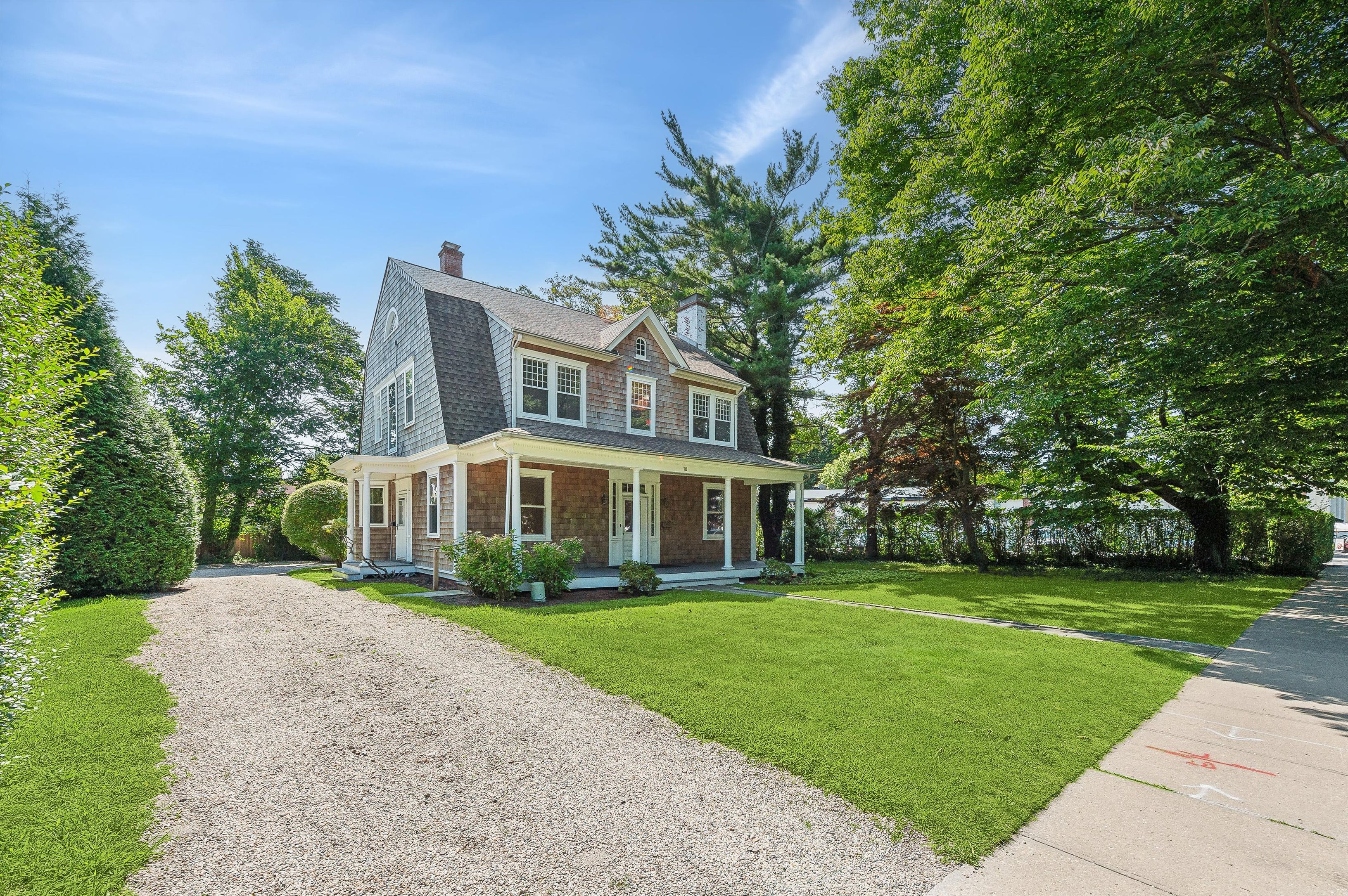 10 Pantigo Road East Hampton, NY 11937 - Photo 4 of 28 a front view of a house with a garden