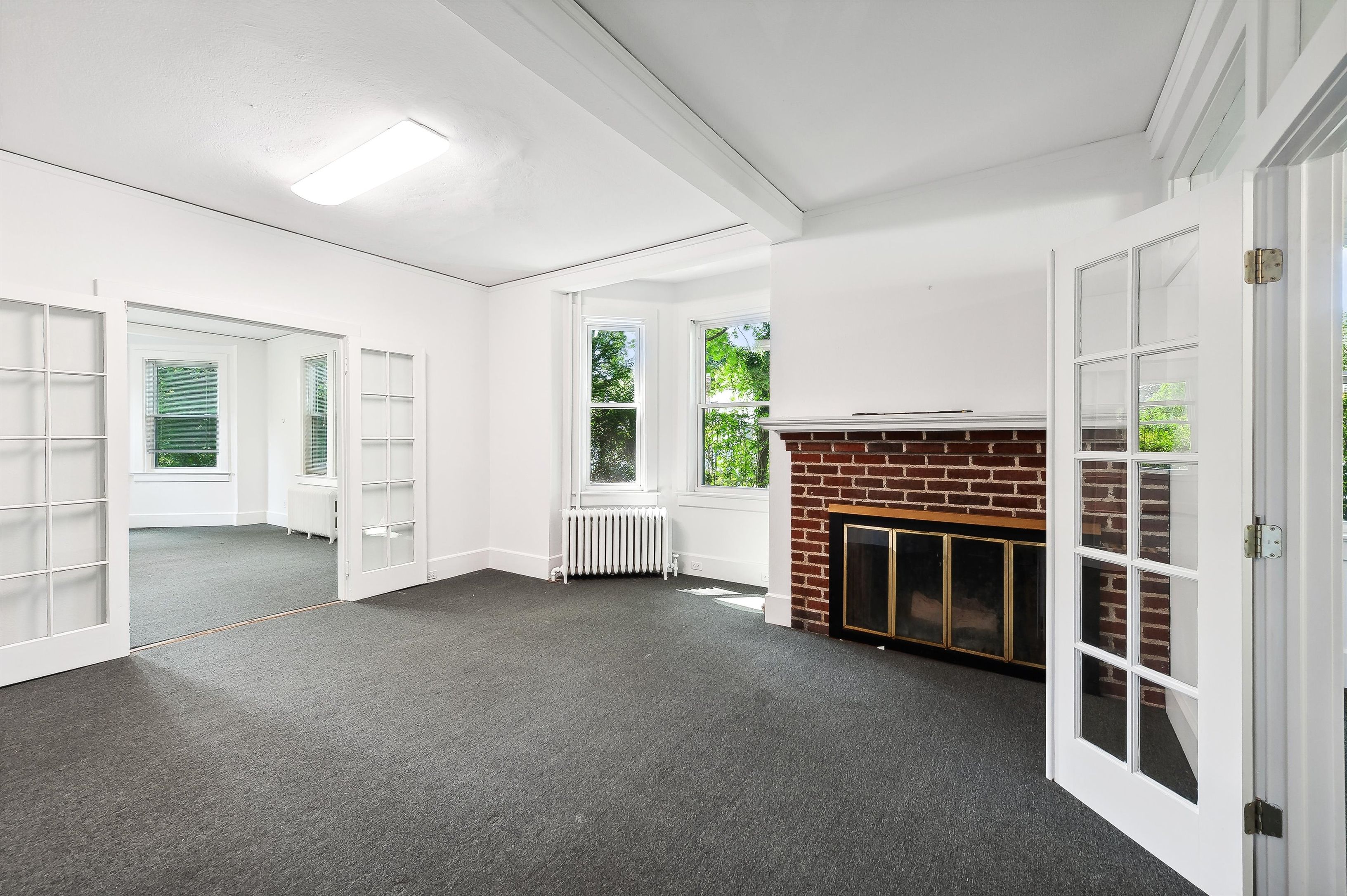 10 Pantigo Road East Hampton, NY 11937 - Photo 10 of 28 an empty room with fireplace and windows