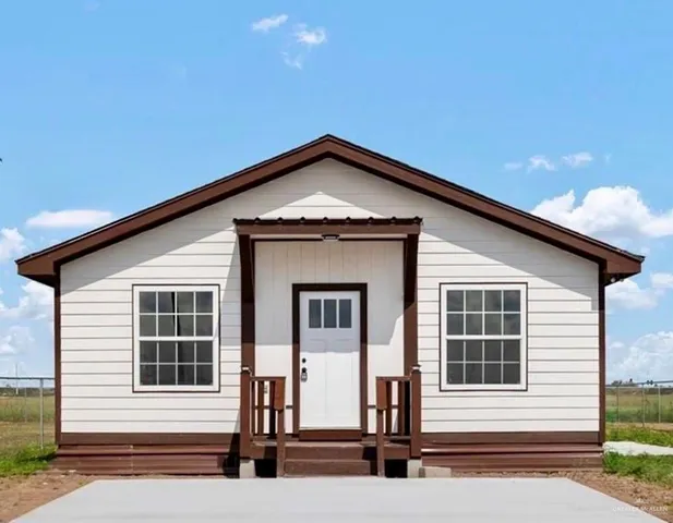 a front view of a house with large windows