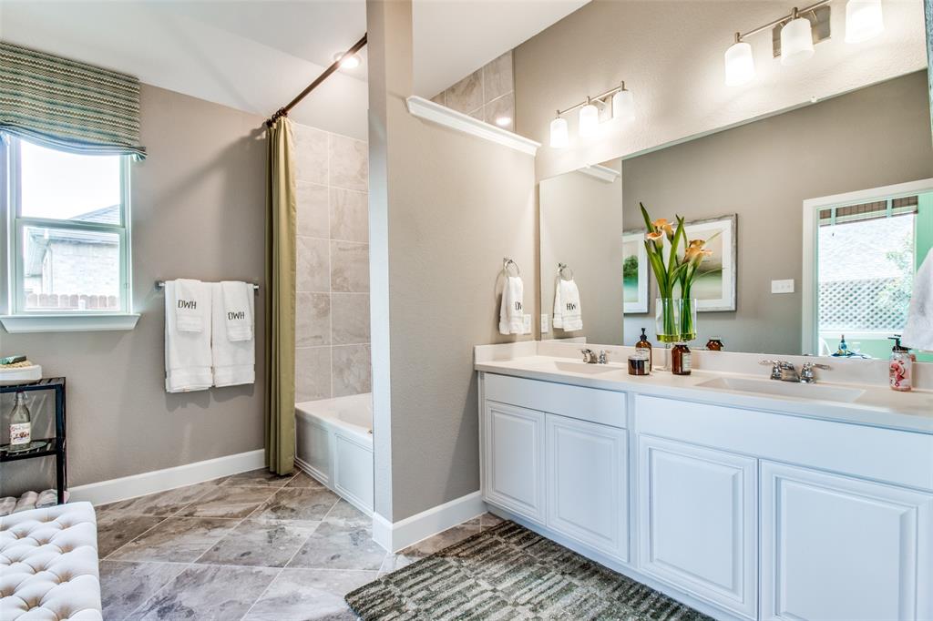1605 Cedar Crest Drive Forney, TX 75126 - Photo 12 of 26 a bathroom with a double vanity sink and a mirror