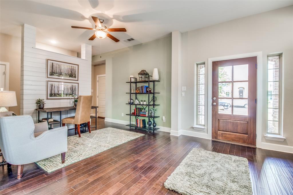 1605 Cedar Crest Drive Forney, TX 75126 - Photo 2 of 26 a living room with furniture and a book shelf