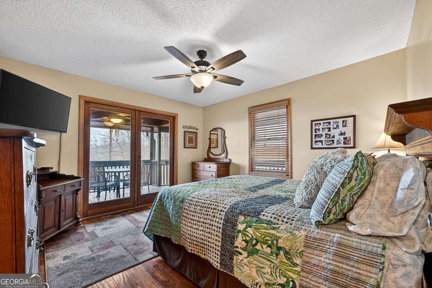 1189 Walnut Ridge, Unit 4044 Ellijay, GA 30536 - Photo 16 of 52 a bedroom with a bed dresser and a flat tv screen