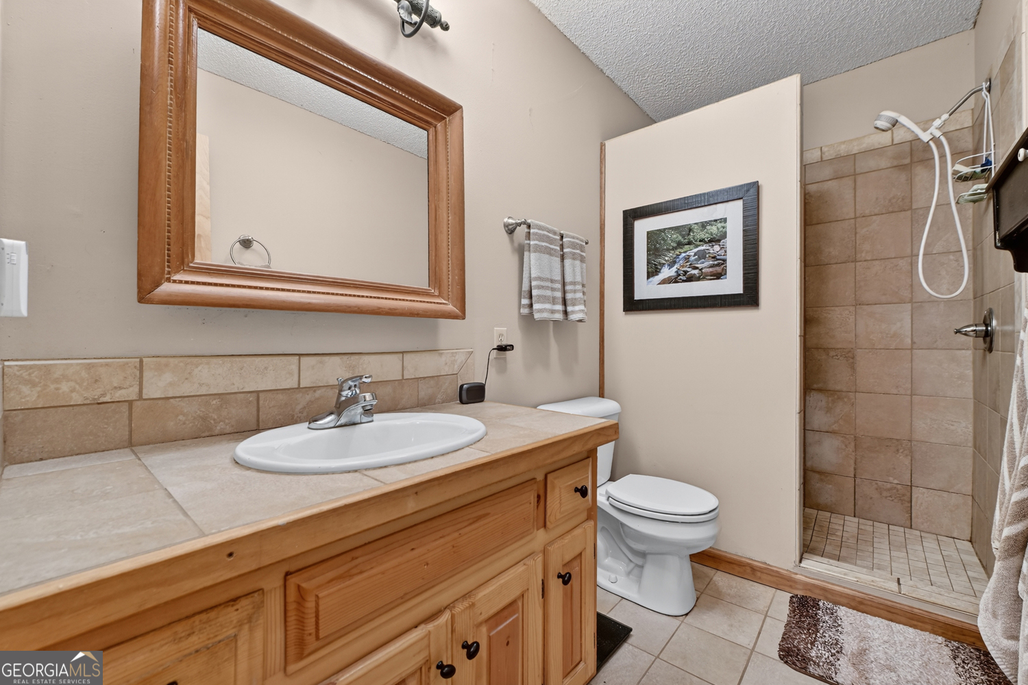 1189 Walnut Ridge, Unit 4044 Ellijay, GA 30536 - Photo 18 of 52 a bathroom with a granite countertop toilet sink and mirror