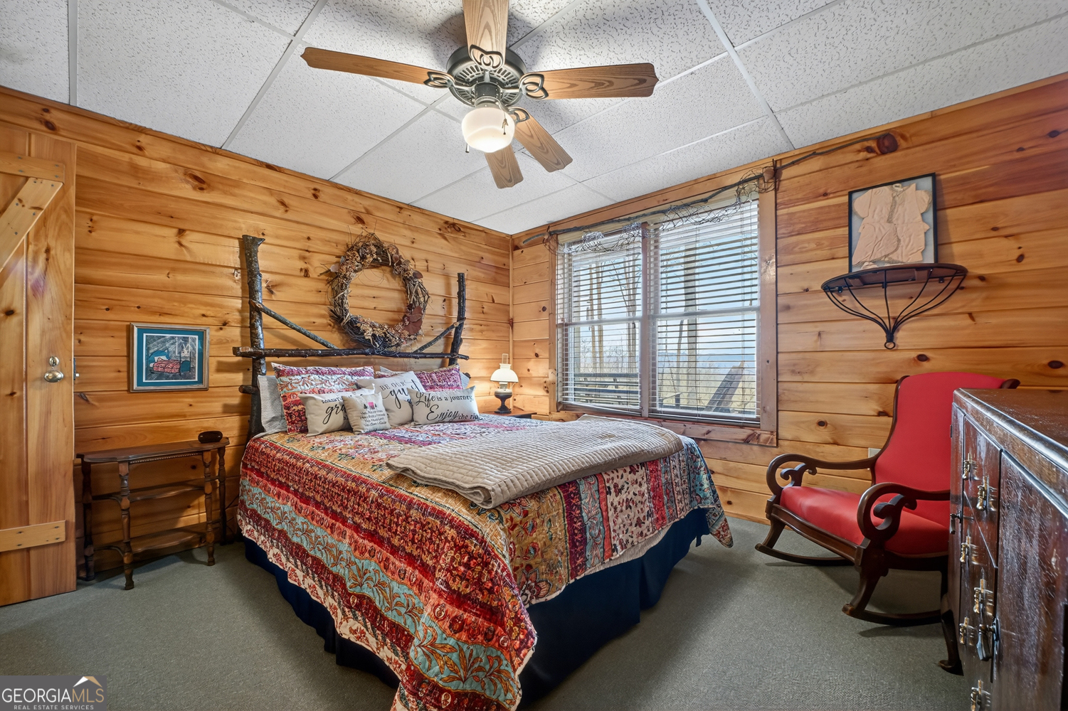 1189 Walnut Ridge, Unit 4044 Ellijay, GA 30536 - Photo 23 of 52 a bedroom with a bed a chandelier and dresser