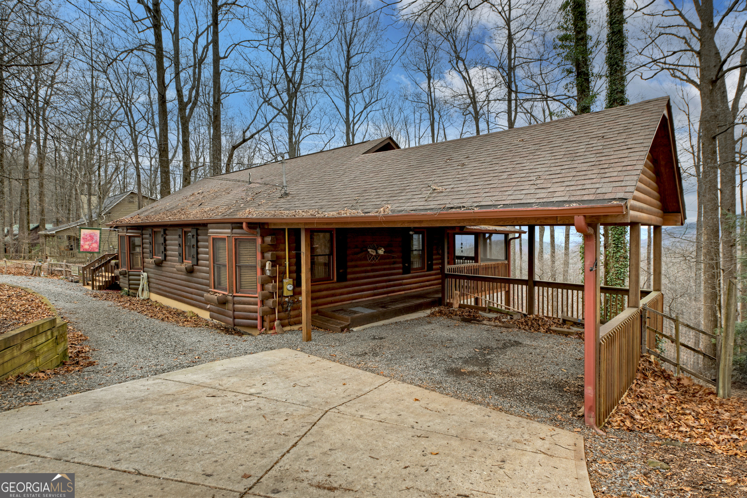 1189 Walnut Ridge, Unit 4044 Ellijay, GA 30536 - Photo 26 of 52 a view of wooden house with a large window and wooden fence