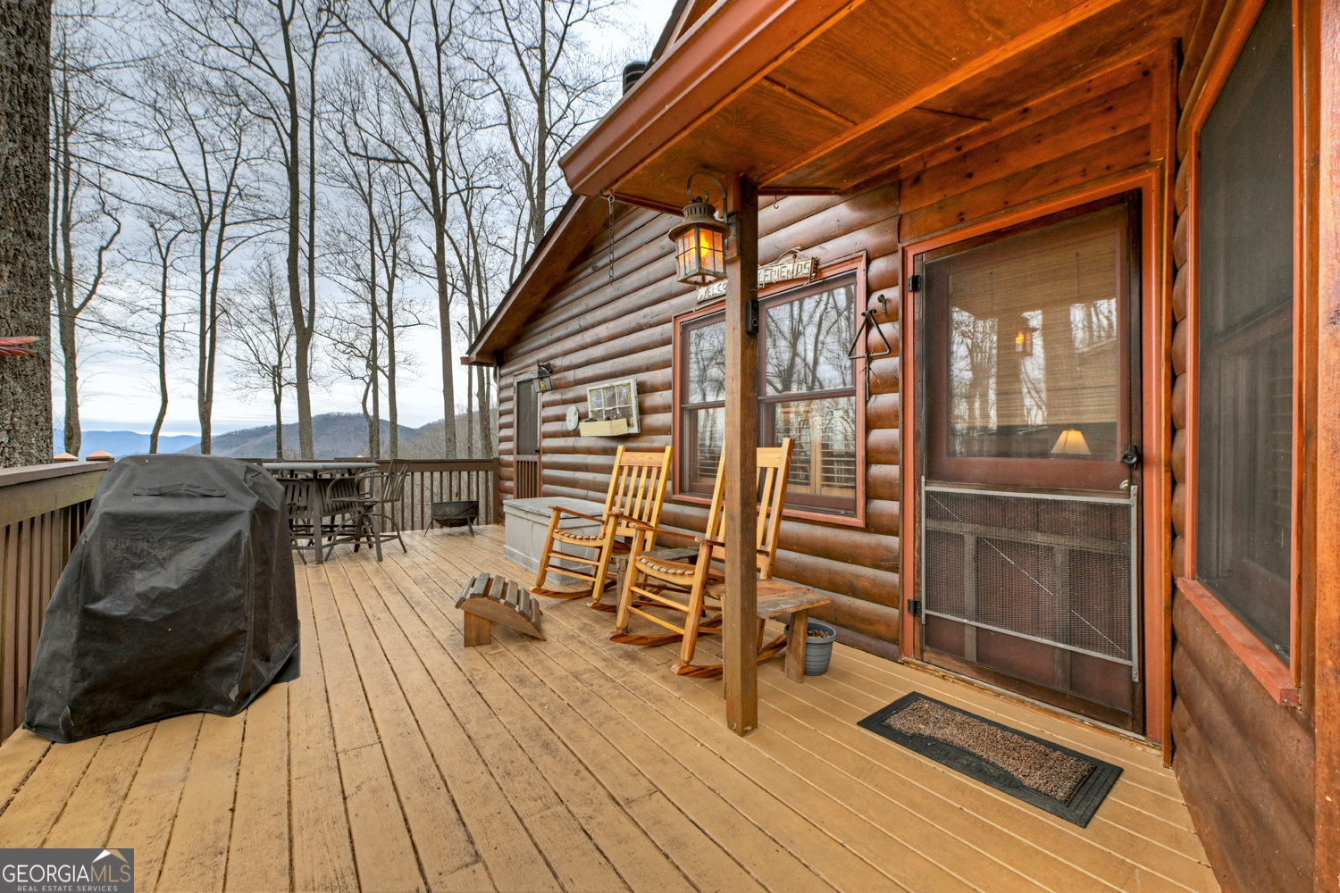 1189 Walnut Ridge, Unit 4044 Ellijay, GA 30536 - Photo 28 of 52 a view of a patio with table and chairs with wooden floor and fence