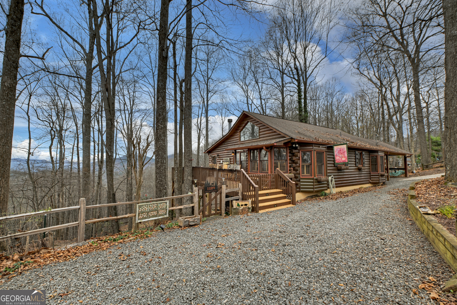 1189 Walnut Ridge, Unit 4044 Ellijay, GA 30536 - Photo 31 of 52 a view of a house with a wooden deck next to a yard