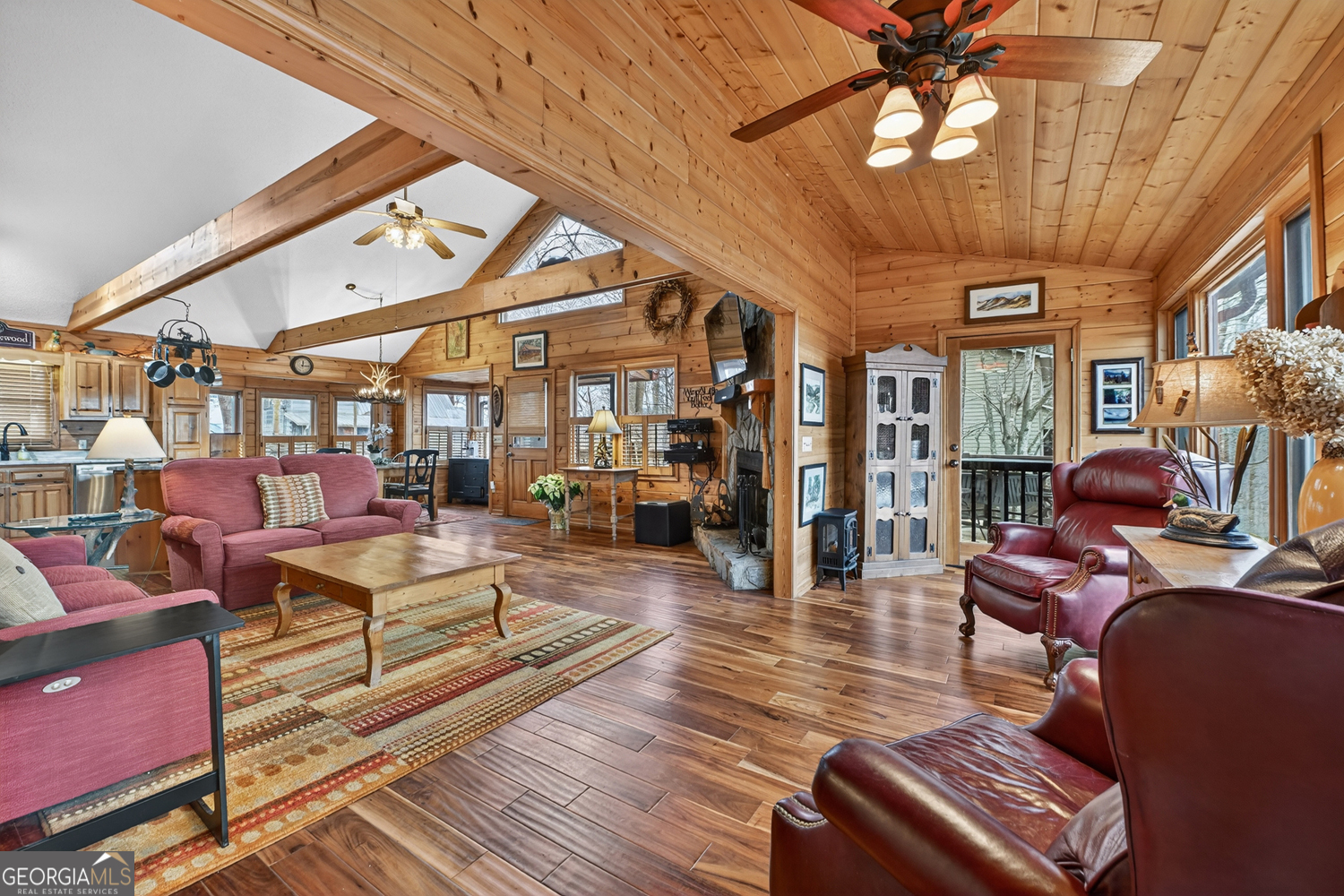 1189 Walnut Ridge, Unit 4044 Ellijay, GA 30536 - Photo 37 of 52 a living room with furniture a flat screen tv and a chandelier