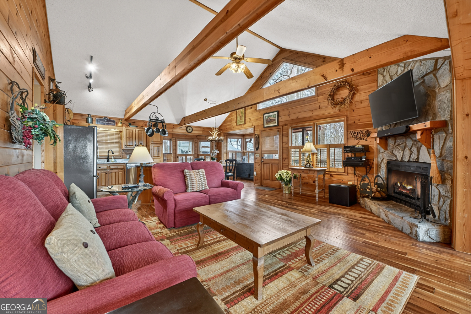 1189 Walnut Ridge, Unit 4044 Ellijay, GA 30536 - Photo 38 of 52 a living room with furniture a flat screen tv and a fireplace
