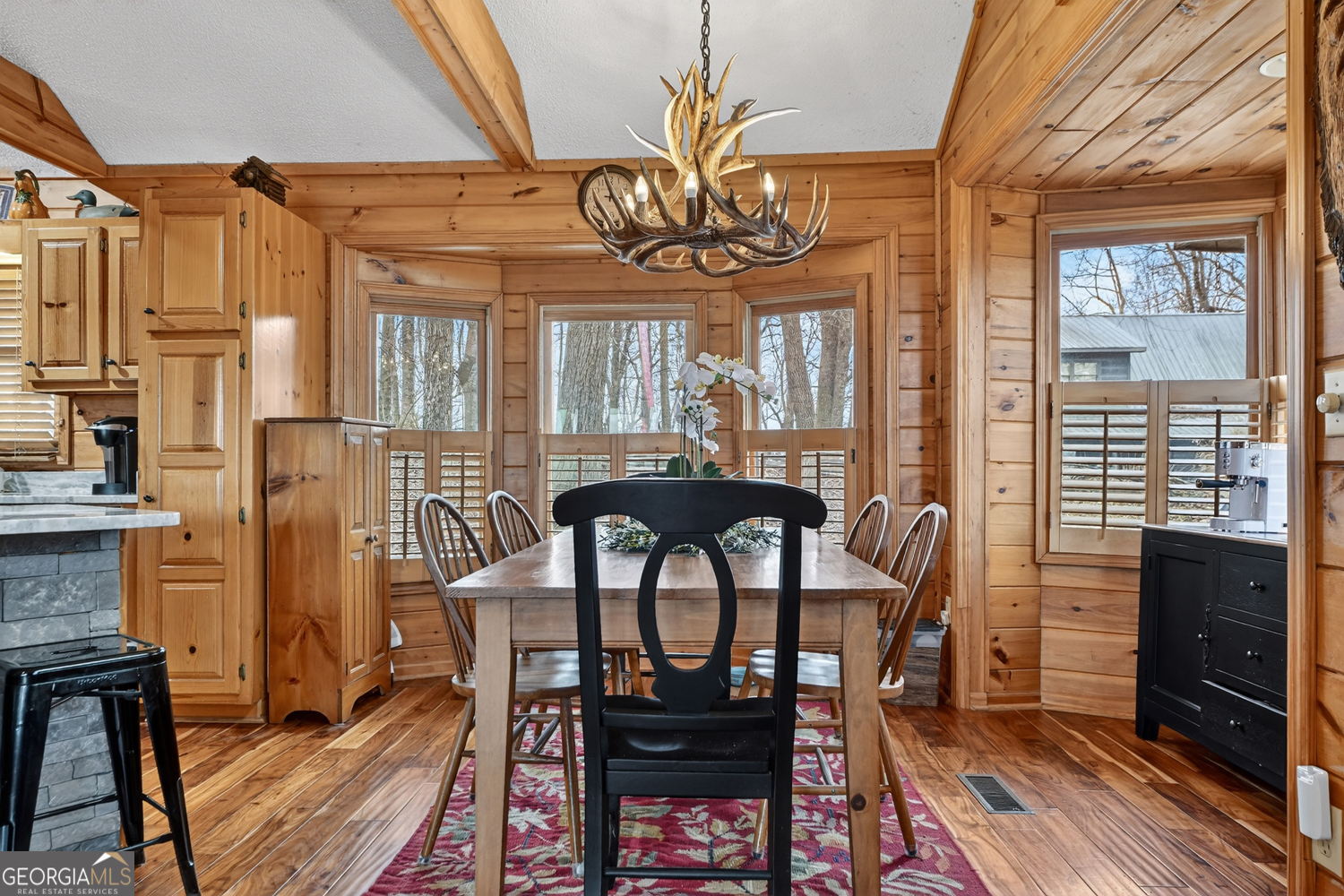 1189 Walnut Ridge, Unit 4044 Ellijay, GA 30536 - Photo 40 of 52 a view of a dining room with furniture window and wooden floor