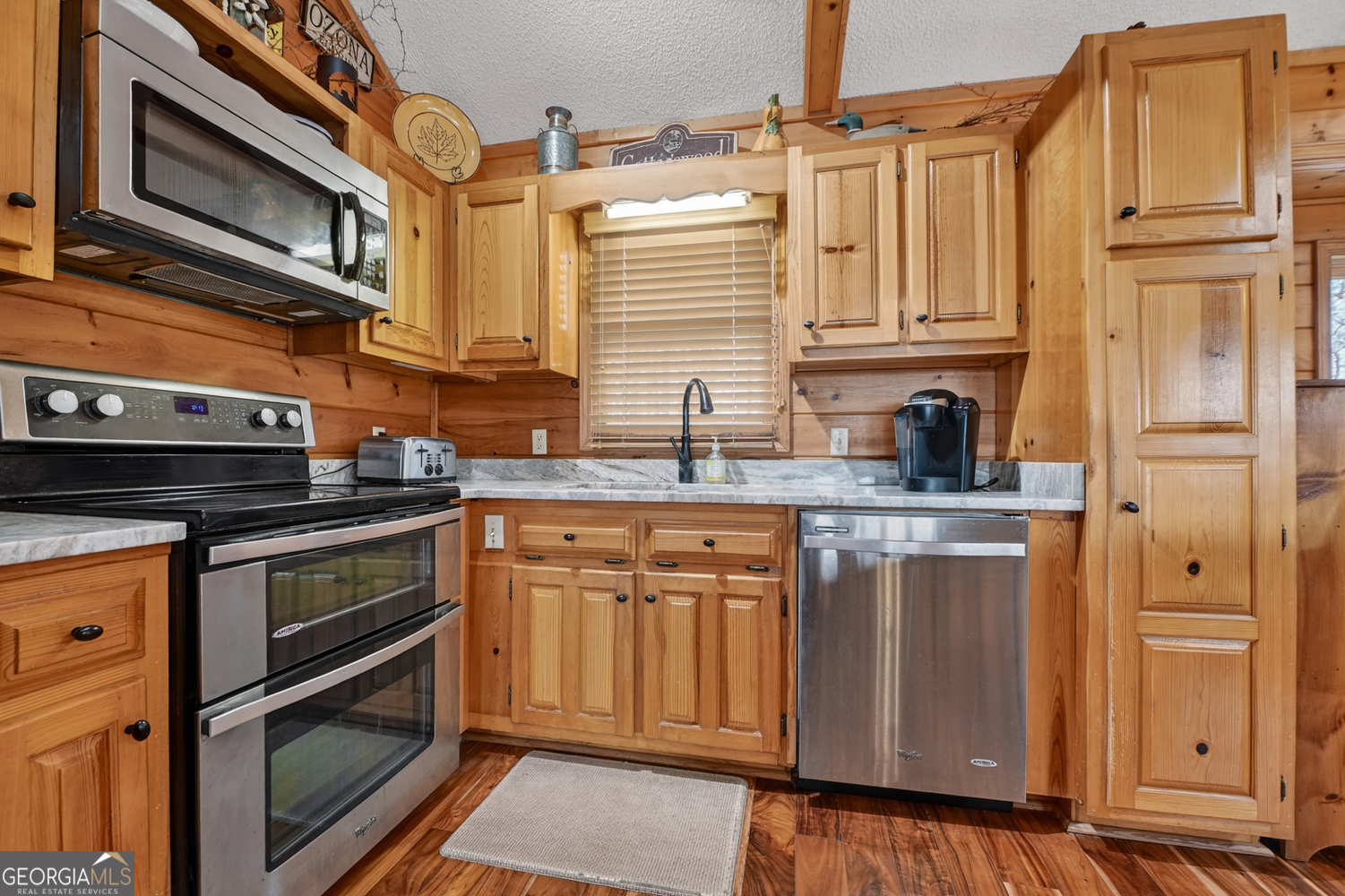 1189 Walnut Ridge, Unit 4044 Ellijay, GA 30536 - Photo 41 of 52 a kitchen with stainless steel appliances granite countertop a stove and a sink