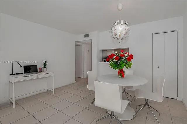 a view of a dining room with furniture wooden floor and a chandelier