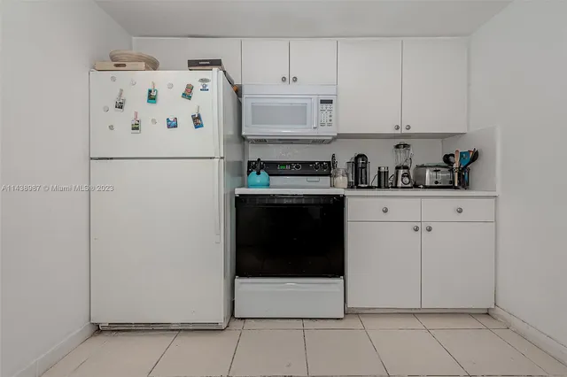 a white refrigerator freezer sitting inside of a kitchen