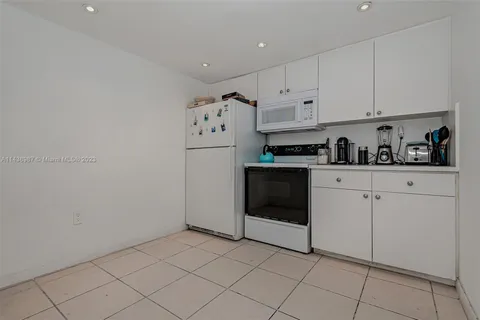 a kitchen with cabinets and appliances