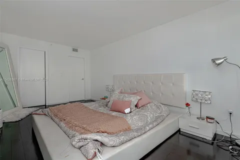 a bedroom with a bed and a table in it