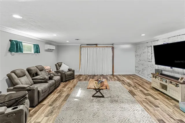 a view of a house with a yard and large tree