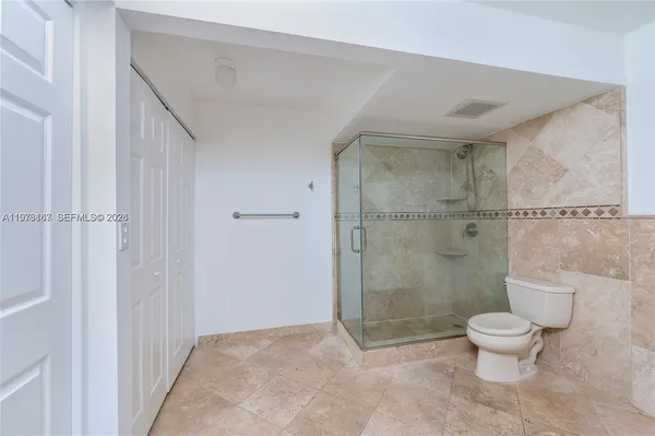 a bathroom with a toilet and a shower