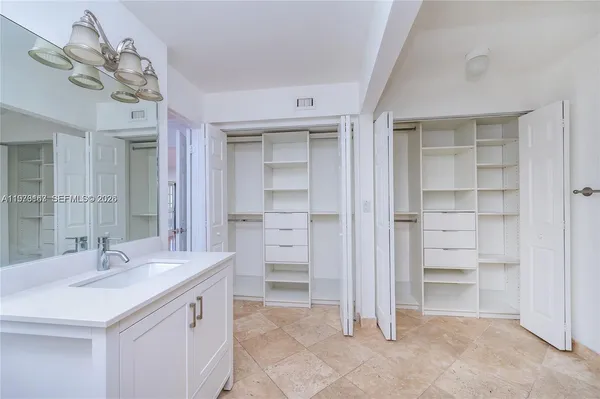 a bathroom with a double vanity sink a vanity and a mirror