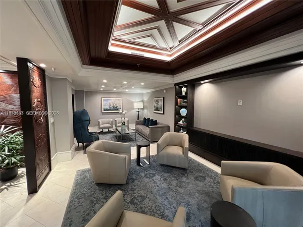 a large living room with furniture and a chandelier