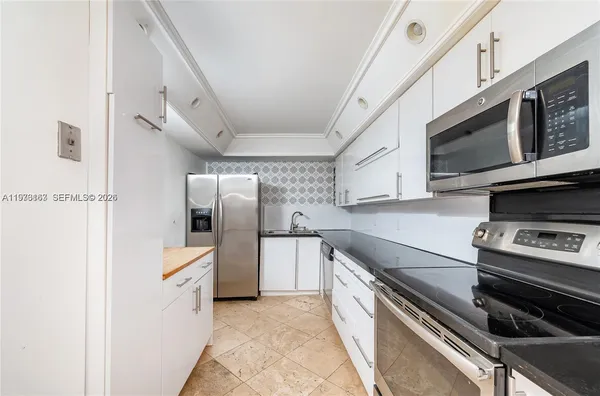 a kitchen with stainless steel appliances and cabinets