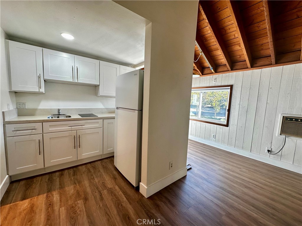 31601 Vía Conejo, Unit 145C Coto de Caza, CA 92679 - Photo 3 of 5 a kitchen with wooden floors and white appliances