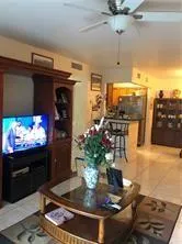 a kitchen with a refrigerator and a potted plant