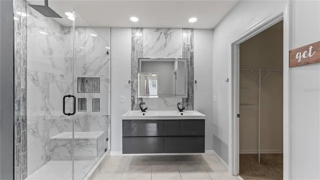 a bathroom with a double vanity sink a mirror and shower