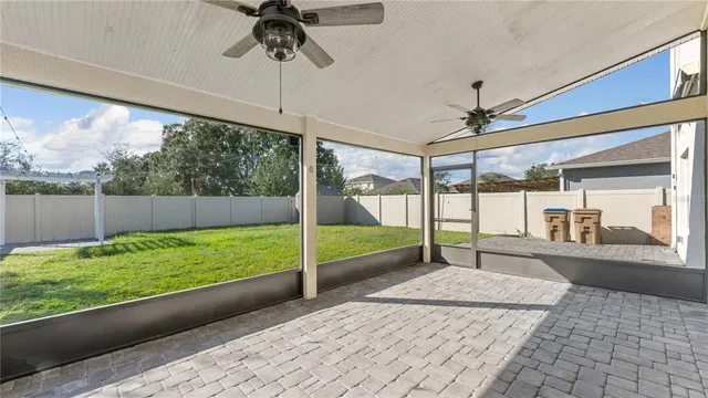 a bedroom with furniture and large windows