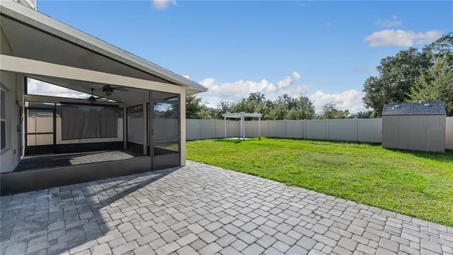 a view of backyard with trampoline