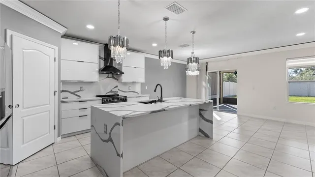 a kitchen with kitchen island a sink stainless steel appliances and cabinets