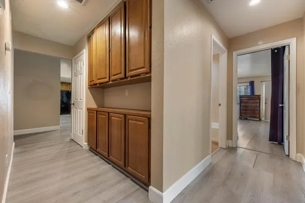 a view of a hallway with wooden floor