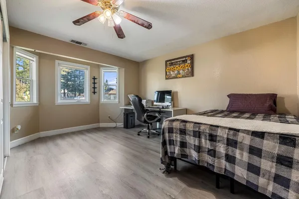a bedroom with a bed and a chandelier