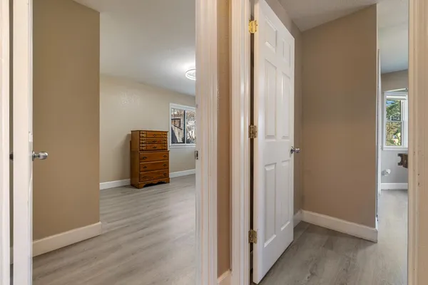 a view of an empty room and wooden floor