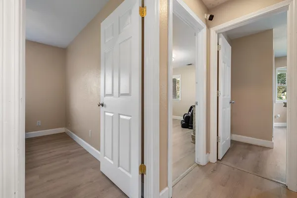 a view of a hallway with wooden shelves