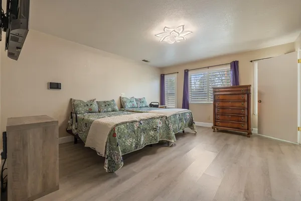 a bedroom with a bed and a chandelier