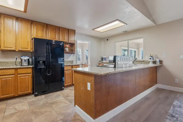 a kitchen with stainless steel appliances granite countertop a refrigerator stove and sink