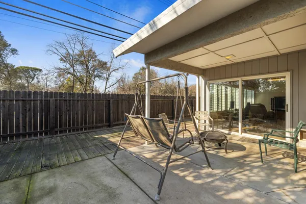 a building outdoor space with patio furniture and potted plants