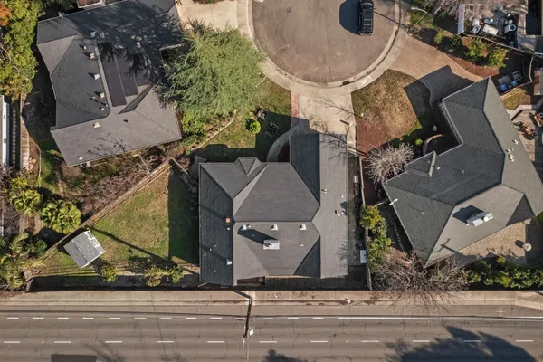 an aerial view of a house with a yard and a garage