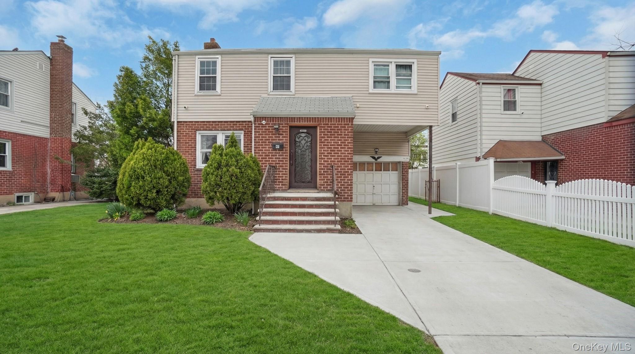 34 Diamond Street Elmont, NY 11003 - Photo 1 of 20 a front view of a house with a yard and trees