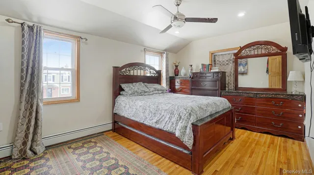a bedroom with a bed and a dresser with mirror
