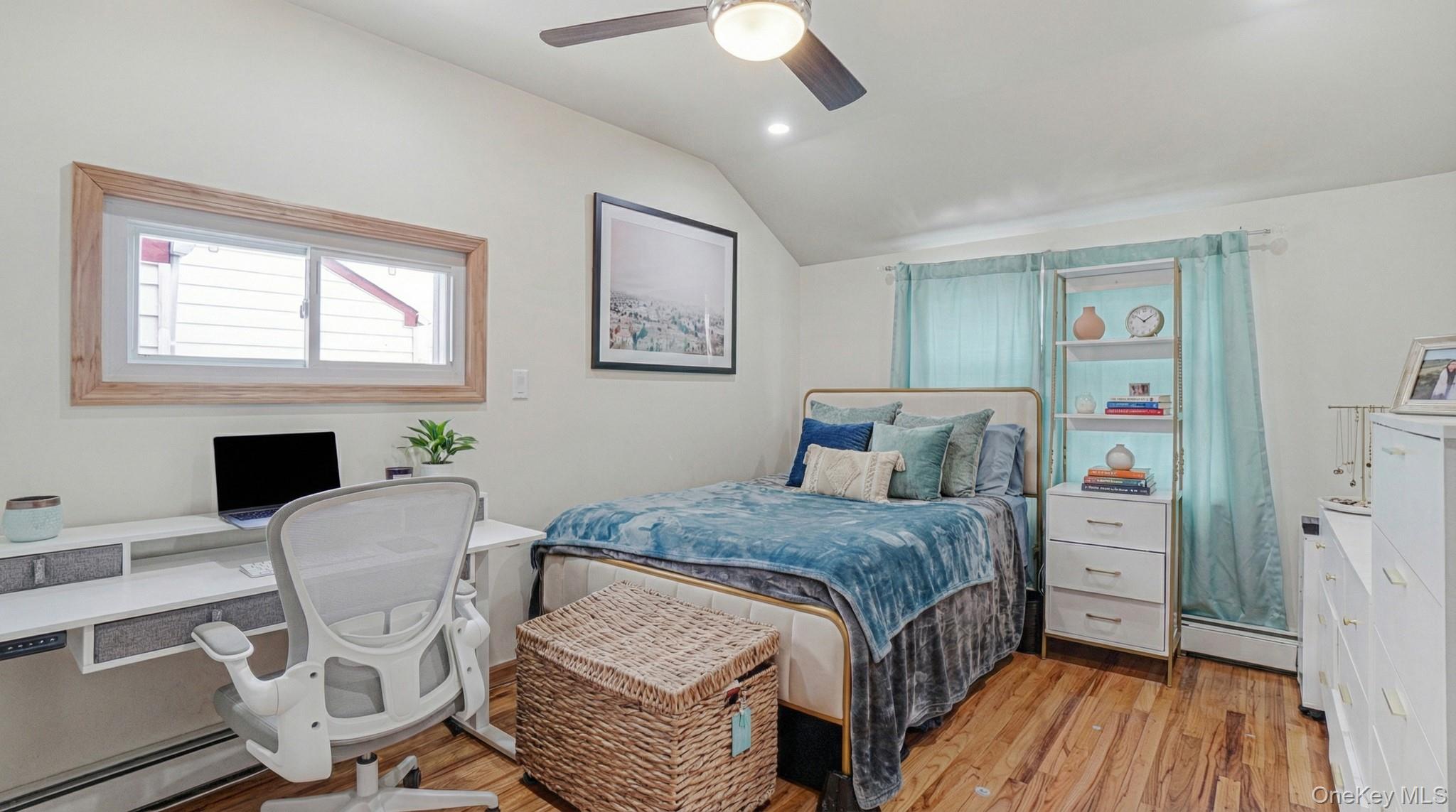 34 Diamond Street Elmont, NY 11003 - Photo 14 of 20 a bedroom with a bed wooden floor and a fireplace