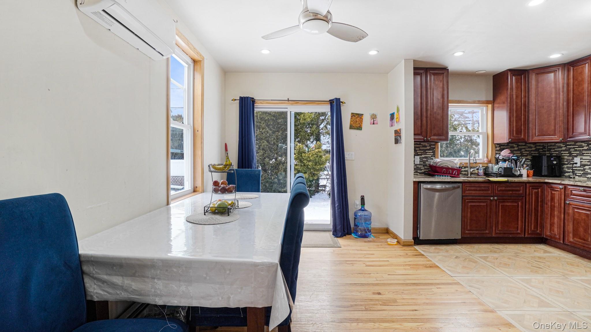 34 Diamond Street Elmont, NY 11003 - Photo 5 of 20 a dining room with a table chairs and kitchen view