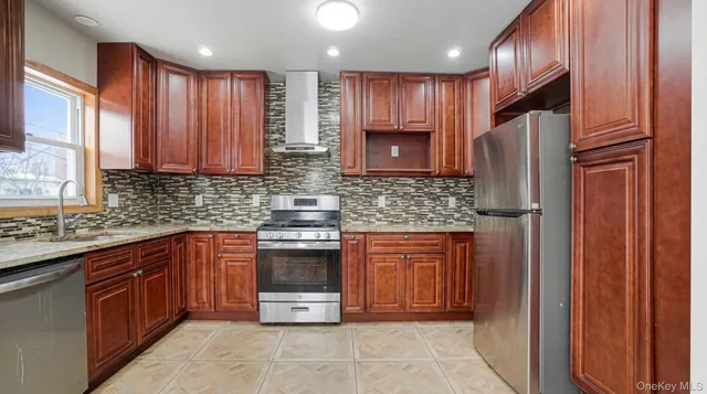 a kitchen with stainless steel appliances granite countertop wooden cabinets a stove top oven a sink and dishwasher