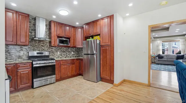 a kitchen with stainless steel appliances granite countertop a refrigerator stove and sink