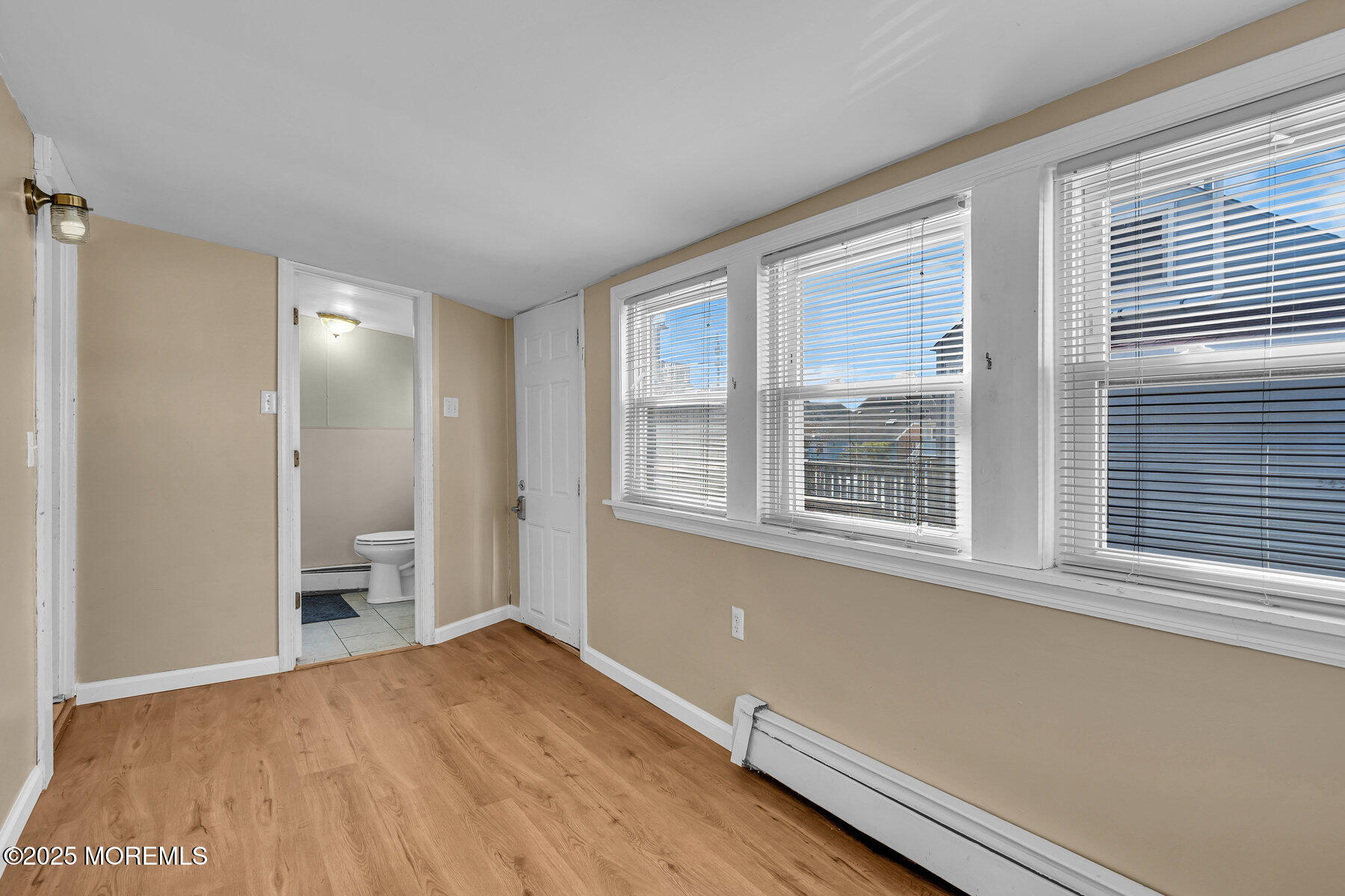 549 Brielle Road, Unit PART A Manasquan, NJ 08736 - Photo 7 of 17 a view of an empty room with a window and wooden floor
