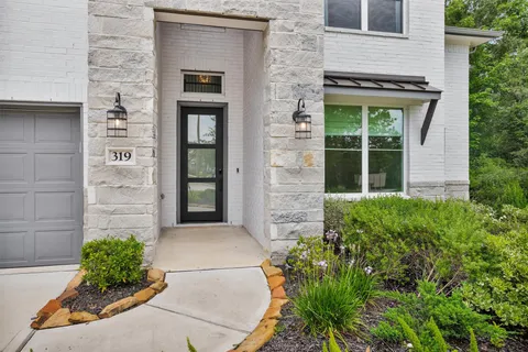 a couple of potted plants in front of door