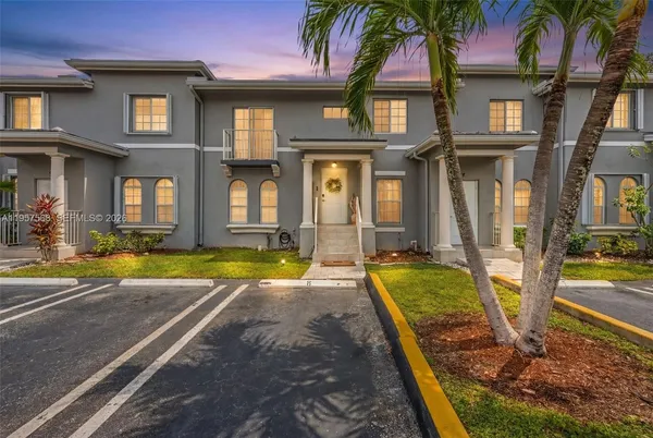 a view of an house with swimming pool and a small yard